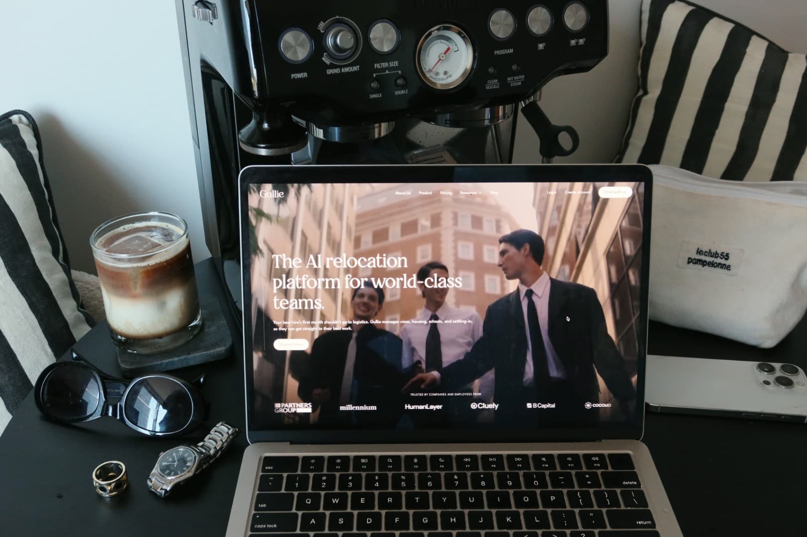The new Gullie homepage on a laptop, next to an espresso machine